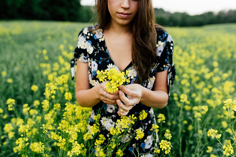 Woman in a field of yellow flowers