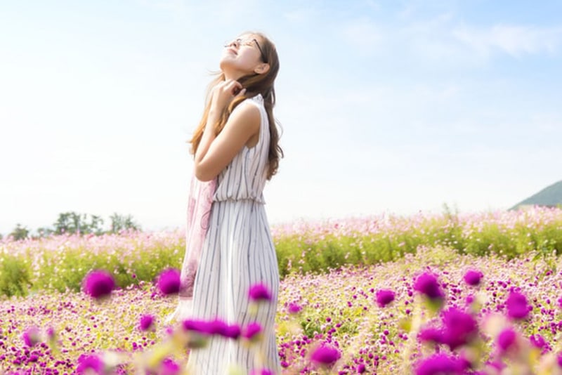 A woman in a field of pink flowers