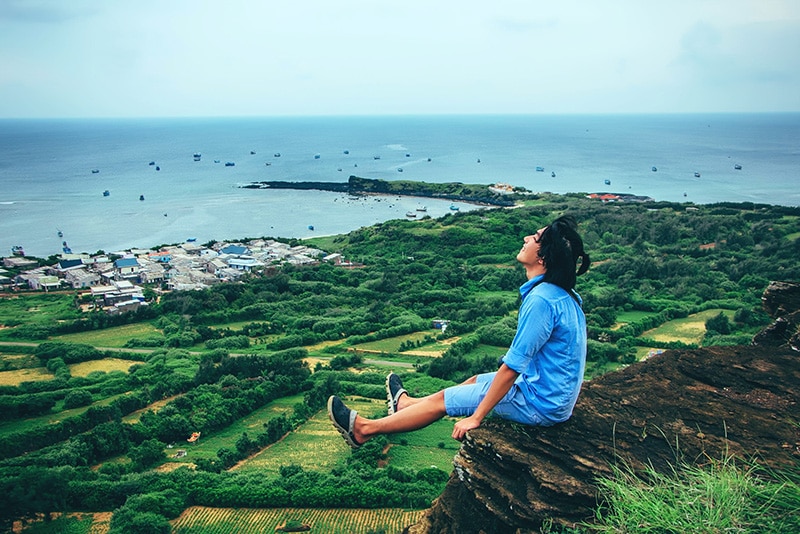 Woman Sitting on a Ledge